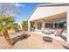 Outdoor patio featuring a seating area and fire pit, perfect for enjoying the backyard's desert landscape at 2633 Flare Star Dr, Henderson, NV 89044