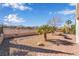 Spacious backyard showcasing desert landscaping, a fire pit, and privacy fencing at 2633 Flare Star Dr, Henderson, NV 89044