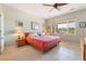 Inviting bedroom featuring a cozy bed, a ceiling fan, and a large window at 2633 Flare Star Dr, Henderson, NV 89044