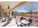 Inviting covered patio featuring outdoor seating, ceiling fan, and desert landscaping at 2633 Flare Star Dr, Henderson, NV 89044