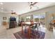 Well-lit dining area adjacent to living room with view to the outdoor patio at 2633 Flare Star Dr, Henderson, NV 89044