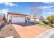 Lovely one-story home featuring a two-car garage, neatly arranged desert landscaping, and a charming front lawn at 2633 Flare Star Dr, Henderson, NV 89044