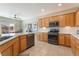 Open kitchen featuring wood cabinets, stainless appliances, and an adjacent patio at 2633 Flare Star Dr, Henderson, NV 89044