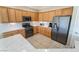 Bright kitchen with stainless steel refrigerator and oven, granite counters, and wooden cabinetry at 2633 Flare Star Dr, Henderson, NV 89044