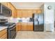 Well-lit kitchen with stainless steel appliances, wood cabinets, and granite countertops at 2633 Flare Star Dr, Henderson, NV 89044