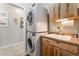 Convenient laundry area with stacked washer/dryer and a utility sink at 2633 Flare Star Dr, Henderson, NV 89044