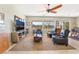 Bright living room with ceiling fan, large windows and comfortable seating arrangement at 2633 Flare Star Dr, Henderson, NV 89044