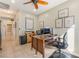 Well-lit office space featuring a ceiling fan, desk, tile floors, and natural light at 2633 Flare Star Dr, Henderson, NV 89044