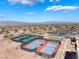 Scenic aerial view of community tennis courts with mountain views and blue skies at 2633 Flare Star Dr, Henderson, NV 89044