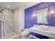 Modern bathroom with a glass bowl sink, mosaic tiled shower, and artistic blue wall at 2700 Las Vegas Blvd # 4002, Las Vegas, NV 89109