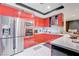 Modern kitchen featuring bright red cabinets, stainless steel appliances, and ample countertop space at 2700 Las Vegas Blvd # 4002, Las Vegas, NV 89109