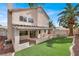 Backyard featuring a covered patio, green grass and low-maintenance desert landscaping at 271 Francisco St, Henderson, NV 89014