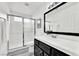 Bathroom featuring a shower with glass doors, tiled walls, toilet, and mirror at 271 Francisco St, Henderson, NV 89014