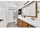 Bright bathroom with double sinks, wood cabinets, and shower-tub combination at 271 Francisco St, Henderson, NV 89014