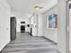 Modern eat-in kitchen with white cabinets, stainless steel appliances, and gray wood-look flooring at 271 Francisco St, Henderson, NV 89014