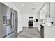 Bright kitchen featuring white cabinetry, stainless steel appliances, and modern gray flooring at 271 Francisco St, Henderson, NV 89014