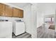 Laundry room with modern washer and dryer and overhead cabinets at 271 Francisco St, Henderson, NV 89014