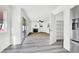 Bright living room with sliding door access to outside, a ceiling fan, fireplace, and adjacent pantry at 271 Francisco St, Henderson, NV 89014