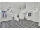 Open-concept living room with new gray flooring, spiral staircase, and ample natural light at 271 Francisco St, Henderson, NV 89014