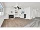 Carpeted living room features a fireplace, built-in shelving, and a ceiling fan at 271 Francisco St, Henderson, NV 89014