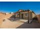 Backyard featuring a covered patio, gravel landscape and block wall fencing for privacy at 2721 Benton Cove St, Laughlin, NV 89029