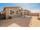 View of the backyard featuring a covered patio, gravel ground cover and secure block wall surrounds at 2721 Benton Cove St, Laughlin, NV 89029