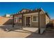 View of covered backyard patio with concrete base, three windows, and a glass sliding door at 2721 Benton Cove St, Laughlin, NV 89029