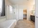 Bright bathroom featuring a large soaking tub and separate glass shower enclosure at 2721 Benton Cove St, Laughlin, NV 89029