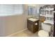 Bathroom with a single sink vanity, granite countertop, tile flooring, and an open shelving unit for storage at 2721 Benton Cove St, Laughlin, NV 89029