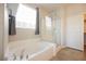 Large soaking tub and separate shower in primary bath with natural light at 2721 Benton Cove St, Laughlin, NV 89029