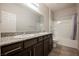 Bathroom featuring granite countertops, dual sinks, modern fixtures and a bathtub-shower combo at 2721 Benton Cove St, Laughlin, NV 89029