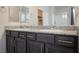 Bathroom featuring granite countertops, dual sinks, modern fixtures and a shower behind glass at 2721 Benton Cove St, Laughlin, NV 89029