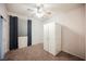 Bedroom features neutral carpet, ceiling fan, closet and bright window at 2721 Benton Cove St, Laughlin, NV 89029