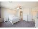 Carpeted bedroom featuring a ceiling fan, large windows, and neutral paint at 2721 Benton Cove St, Laughlin, NV 89029