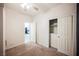 Carpeted bedroom featuring a closet, neutral walls, a ceiling fan, and an open door looking out to the kitchen area at 2721 Benton Cove St, Laughlin, NV 89029