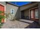 Charming courtyard with stone pavers, colorful plants, and a seating area with a table and chairs at 2721 Benton Cove St, Laughlin, NV 89029