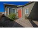 Inviting front entrance with a charming orange door and manicured landscaping at 2721 Benton Cove St, Laughlin, NV 89029