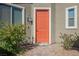 Inviting front entrance with a charming orange door and manicured landscaping at 2721 Benton Cove St, Laughlin, NV 89029