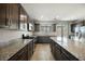 Beautiful kitchen with granite counters, dark wood cabinets, and stainless steel appliances at 2721 Benton Cove St, Laughlin, NV 89029