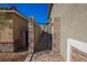 Brick-paved pathway and gated entrance to the side yard, combining practicality with aesthetic appeal at 2721 Benton Cove St, Laughlin, NV 89029