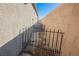 Narrow side yard featuring an air conditioning unit and gated access, ensures functionality and security at 2721 Benton Cove St, Laughlin, NV 89029