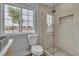 Modern bathroom featuring a glass shower, granite sink, toilet, and bright window at 2749 Horseshoe Dr, Las Vegas, NV 89120