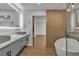 Bathroom featuring a modern vanity with dual sinks, and a free standing tub and glass shower in the background at 2749 Horseshoe Dr, Las Vegas, NV 89120