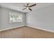 Bedroom with modern lighting, wood-look flooring, and backyard views from a large window at 2749 Horseshoe Dr, Las Vegas, NV 89120