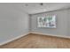 Bright bedroom featuring a large window, neutral walls, and wood-look flooring at 2749 Horseshoe Dr, Las Vegas, NV 89120