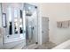 Sleek bathroom with a glass-enclosed shower, marble accents, and vertical windows for natural light at 3030 S Formula Ct, Pahrump, NV 89048