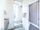 Bathroom featuring stylish wallpaper, glass shower with black fixtures, and stone vanity at 3030 S Formula Ct, Pahrump, NV 89048