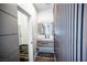 Modern bathroom featuring a floating vanity, stylish mirror and a unique wood-slatted accent wall at 3030 S Formula Ct, Pahrump, NV 89048