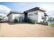 Modern house exterior with a gravel front yard and desert landscaping at 3030 S Formula Ct, Pahrump, NV 89048