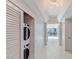 Hallway featuring in-unit washer and dryer, white walls, and tile flooring at 322 Karen Ave # 808, Las Vegas, NV 89109